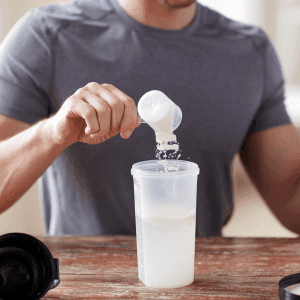 man pouring a measure of powder into a shaker