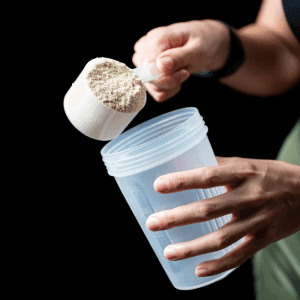 woman pours a measure of the product into a shaker