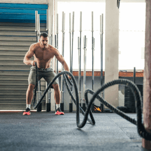 man working out on ropes at the gym