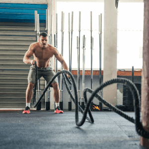 man working out on ropes at the gym